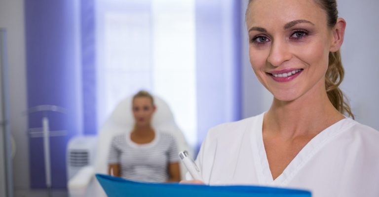 smiling-female-doctor-holding-medical-reports